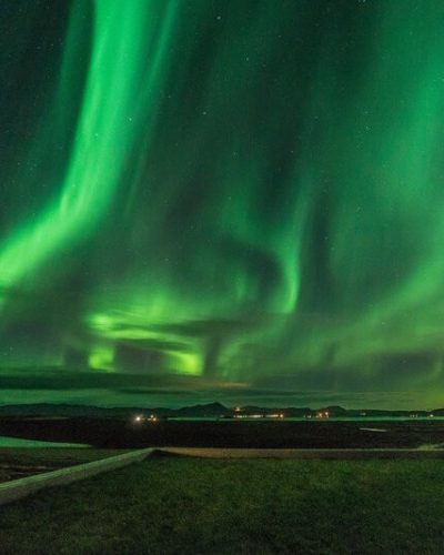 Northern Lights visible from the terrace at Hotel Laxa in Iceland.